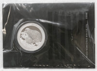 Runde Münze mit geprägtem Adler-Motiv,...