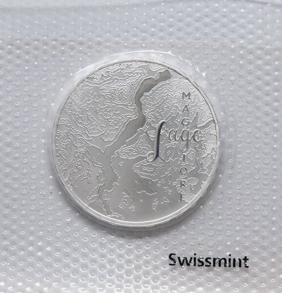 Münze Schweiz 20 Franken 2025 „Lago Maggiore“ Stempelglanz – Vorderseite zeigt Seeansicht, Rückseite Symbol Wasserturm Europa.